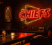 Dark scene with a glowing red and gold neon sign reading CHIEFS