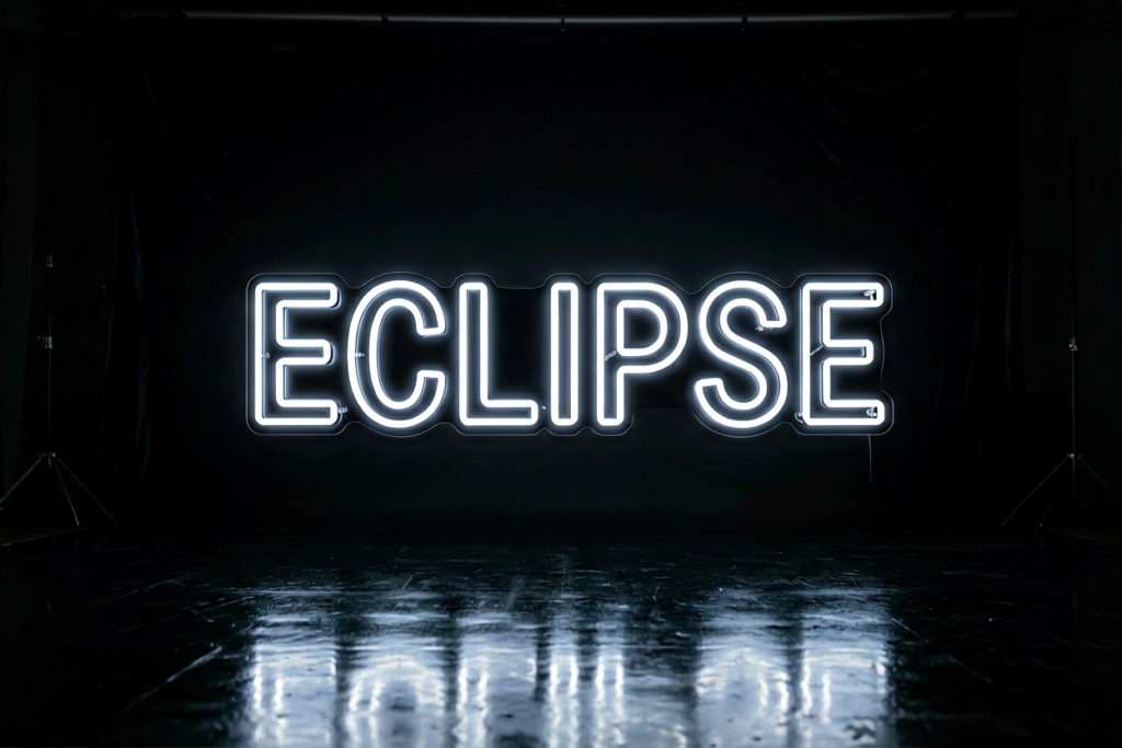 Dark scene with a glowing white on black neon sign reading ECLIPSE