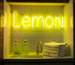 Dark scene with a glowing lemon yellow neon sign reading Lemon